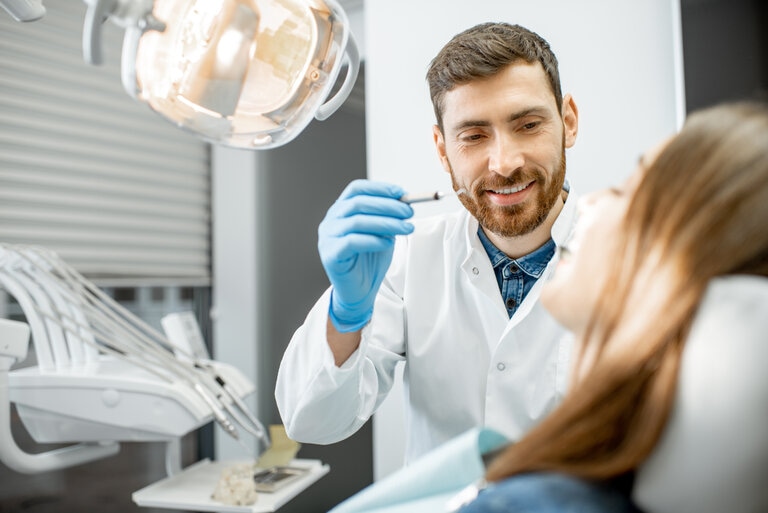 dentist giving oral cancer screening